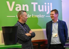 Gerardus Veenema van Van Tuijl in gesprek met een klant. Van Tuijl toonde zowel kartonnen als plastic producten voor de tuinbouw zoals de bloemenemmer en de Eco-Clicktray.